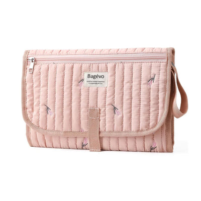 Quilted portable baby changing mat and travel clutch folded in minimalist floral pink tulip print - Available from Senso-Blanky