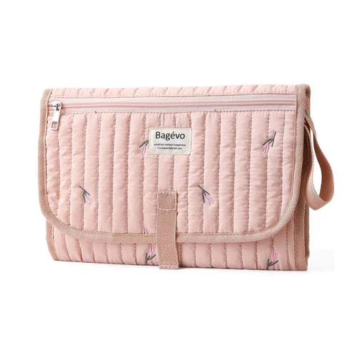 Quilted portable baby changing mat and travel clutch folded in minimalist floral pink tulip print - Available from Senso-Blanky