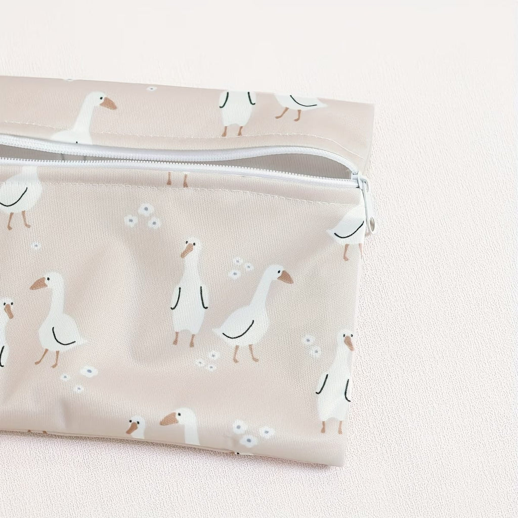 close-up of reusable waterproof wet bag set in dusty pink goose motif - available from Senso-Blanky