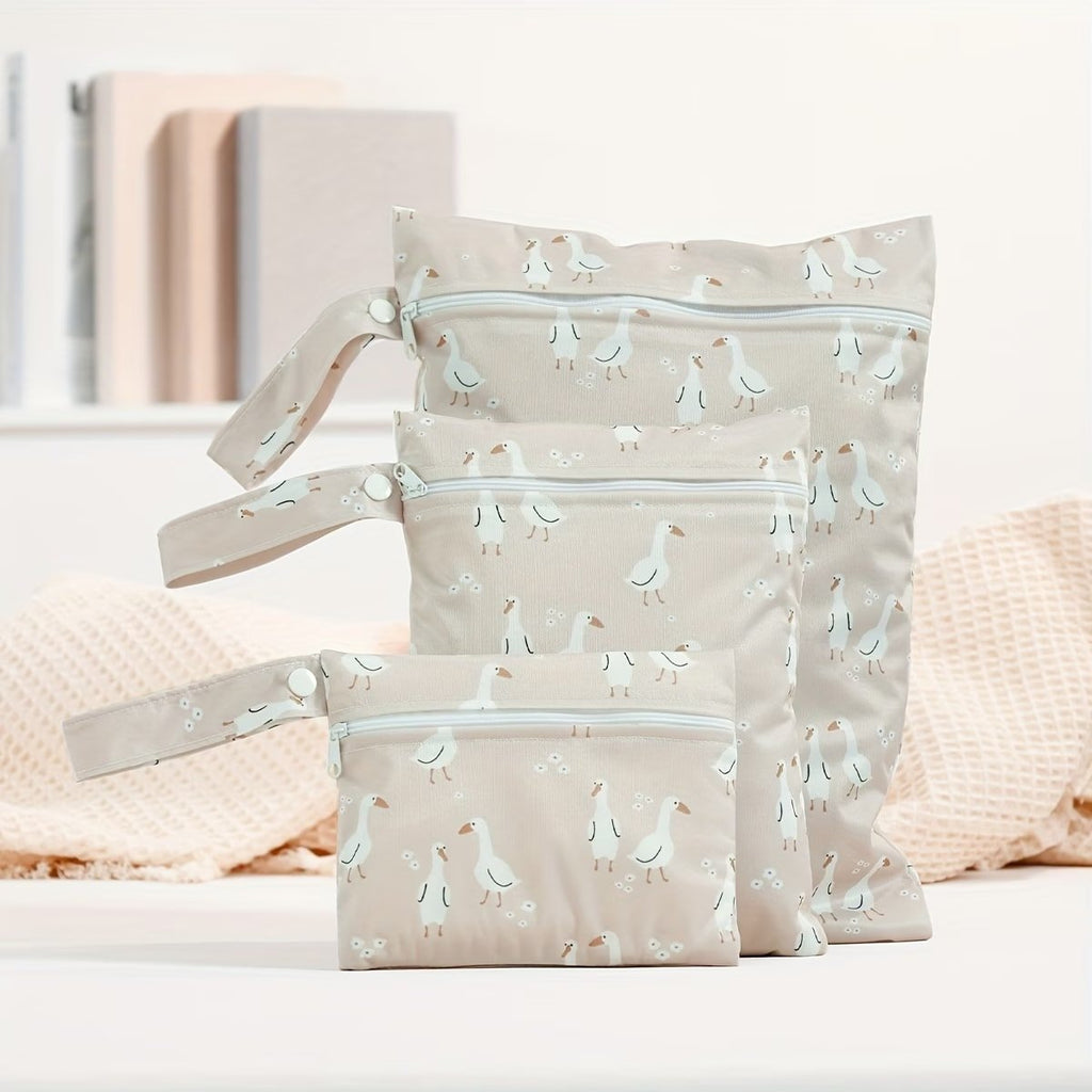 lifestyle image of 3 piece reusable waterproof wet bag set in dusty pink goose motif - Senso-Blanky