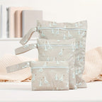 lifestyle image of 3 piece reusable waterproof wet bag set in dusty pink goose motif - Senso-Blanky
