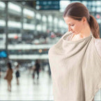 Mother comfortably and discreetly nursing her baby in a public setting using the lightweight cotton shawl - available from Senso-Blanky.