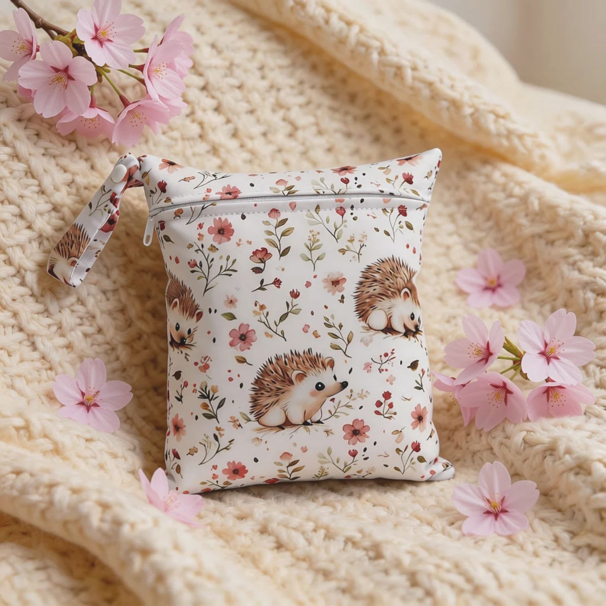 Reusable waterproof wet bag  with adorable hedgehogs design with cherry blossoms for on-the-go parent organization, available from Senso-Blanky.