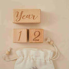 Beautiful milestone block set styled in a modern nursery setting with its accompanying cotton drawstring storage bag.