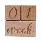 Close-up of crisp engraved lettering and smooth unfinished wood grain texture on baby milestone blocks	Premium Hardwood Texture & Lettering