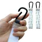 Close-up of durable Green Leaves printed adjustable Velcro strap and heavy-duty metal carabiner clip being opened for stroller - Available from Senso-Blanky