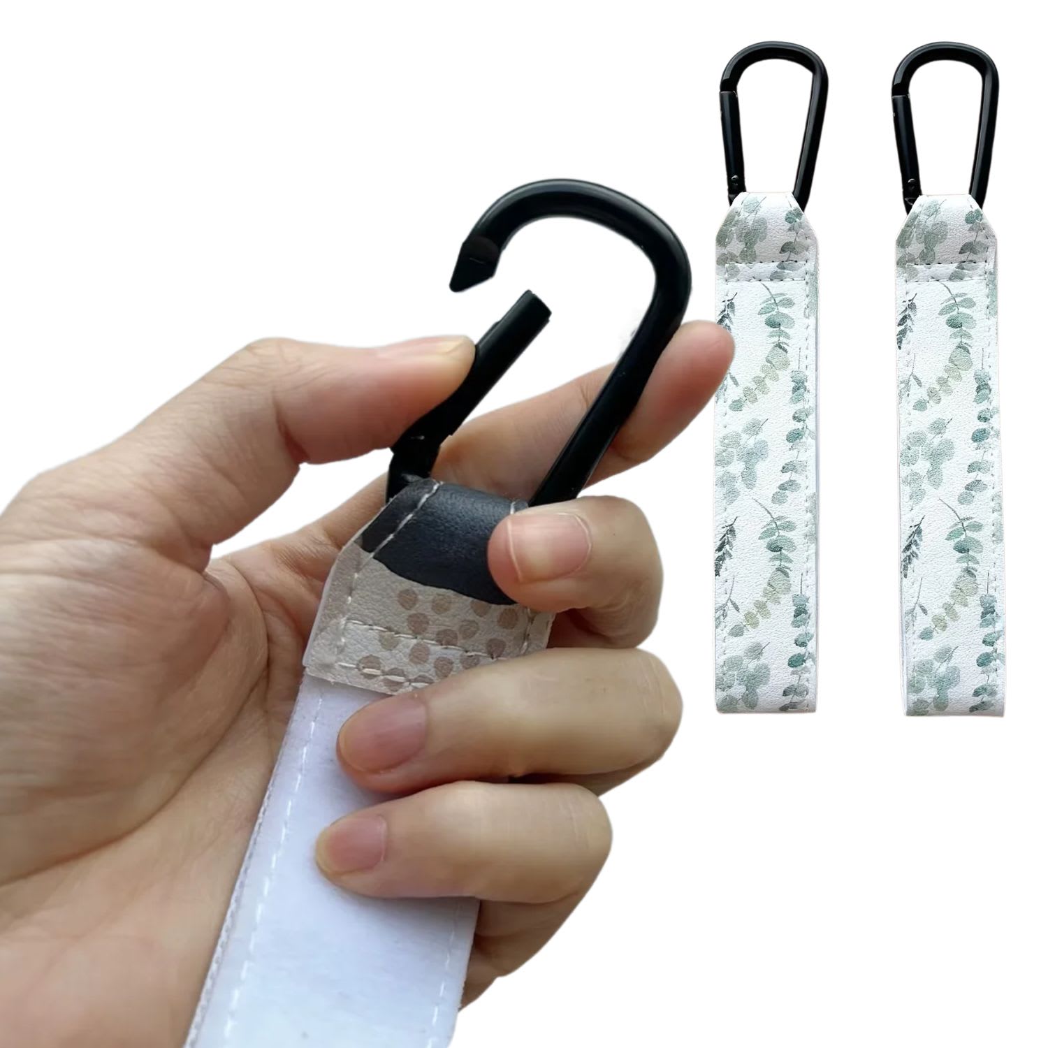 Close-up of durable Green Leaves printed adjustable Velcro strap and heavy-duty metal carabiner clip being opened for stroller - Available from Senso-Blanky
